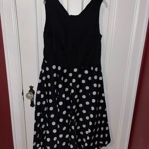 Black dress with white polka dots with zipper back.